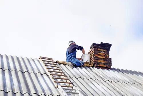 worker making masonry of bricks repairing chimney