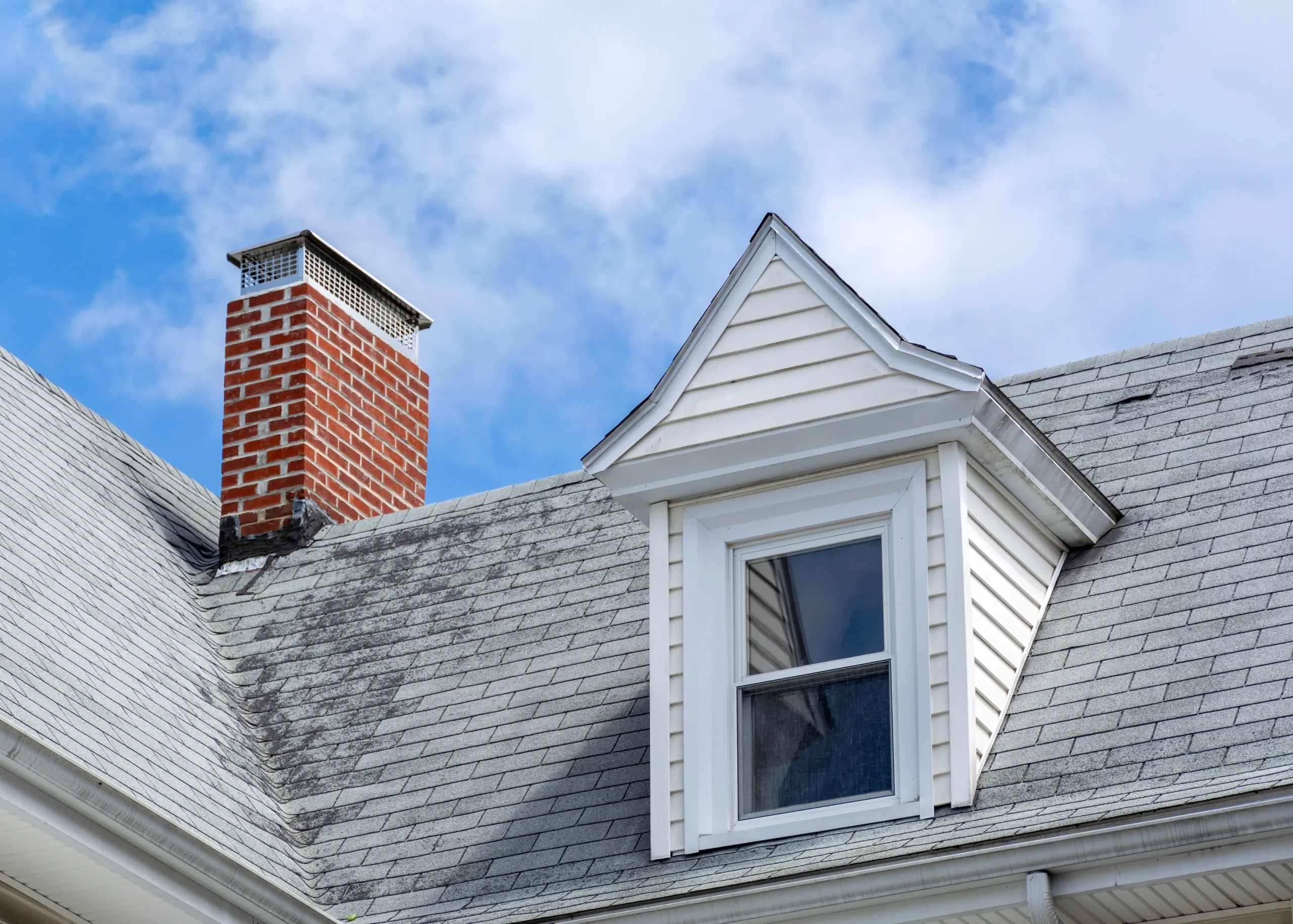 roof of a house with a red brick chimney